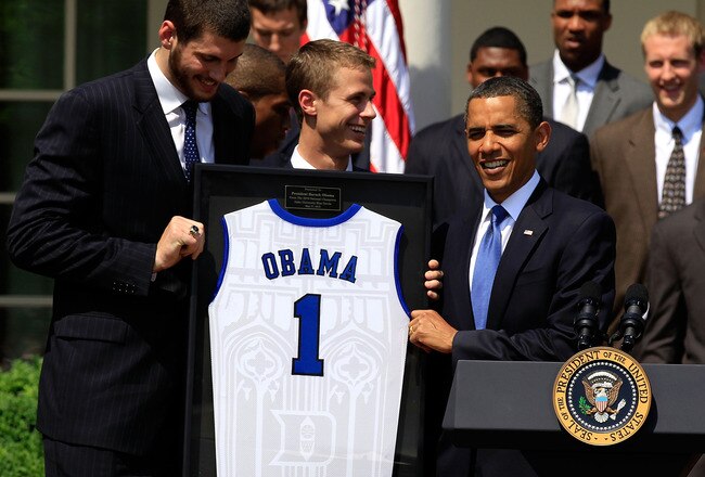 WASHINGTON - MAY 27:  U.S. President Barack Obama (R) receives a jersey from players Brian Zoubek (L) and Jon Scheyer (2nd L) of the Duke Blue Devils during a Rose Garden event May 27, 2010 at the White House in Washington, DC. Obama hosted the NCAA men basketball champions to honor their 2009-2010 season.  (Photo by Alex Wong/Getty Images)