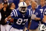 INDIANAPOLIS - JANUARY 24:  Wide receiver Reggie Wayne #87 of the Indianapolis Colts runs the ball while playing against the New York Jets during the AFC Championship Game at Lucas Oil Stadium on January 24, 2010 in Indianapolis, Indiana. The Colts defeated the Jets 30-17.  (Photo by Jonathan Daniel/Getty Images)
