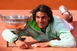 PARIS - JUNE 06:  Rafael Nadal of Spain celebrates with the trophy after winning the men's singles final match between Rafael Nadal of Spain and Robin Soderling of Sweden on day fifteen of the French Open at Roland Garros on June 6, 2010 in Paris, France.  (Photo by Julian Finney/Getty Images)