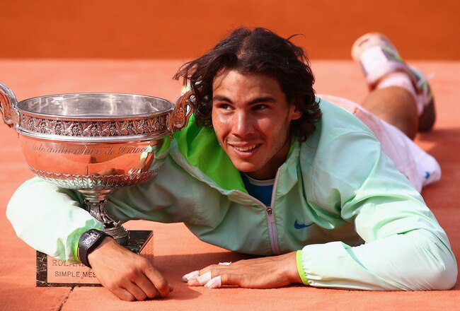 PARIS - JUNE 06:  Rafael Nadal of Spain celebrates with the trophy after winning the men's singles final match between Rafael Nadal of Spain and Robin Soderling of Sweden on day fifteen of the French Open at Roland Garros on June 6, 2010 in Paris, France.  (Photo by Julian Finney/Getty Images)