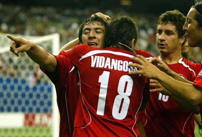MONTREAL, CANADA - JULY 15:  Mauricio Isla #3 of Team Chile celebrates his 1st goal scored in extra time against Team Nigeria with teammate Mathias Vidangossy #18 during their FIFA U-20 World Cup Canada 2007 quarter-final game at Olympic Stadium July 15, 2007 in Montreal, Quebec. (Photo by Dave Sandford/Getty Images)