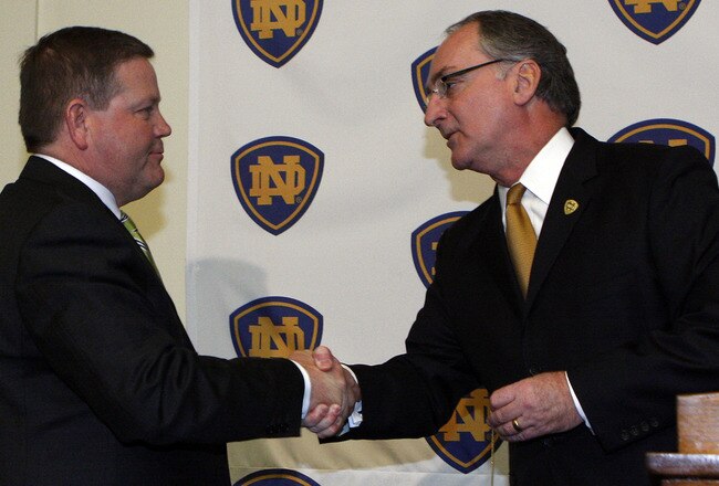 SOUTH BEND, IN - DECEMBER 11: Notre Dame atheletic director Jack Swarbrick (R) greets Brian Kelly as he is introduced as the new football head coach at Notre Dame University on December 11, 2009 in South Bend, Indiana.  Kelly most recently led the University of Cincinnati to two consecutive Bowl Championship Series appearances including a perfect 12-0 record this past season. (Photo by Frank Polich/Getty Images)