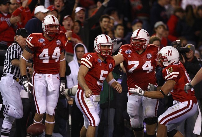 SAN DIEGO - DECEMBER 30:  Quarterback Zac Lee #5 of the University of Nebraska Cornhuskers is mobbed by teammates after scoring the first touchdown against the University of Arizona Wildcats during the Pacific Life Holiday Bowl on December 30, 2009 at Qualcomm Stadium in San Diego, California. The Cornhuskers defeated the Wildcats 33-0. (Photo By Donald Miralle/Getty Images)