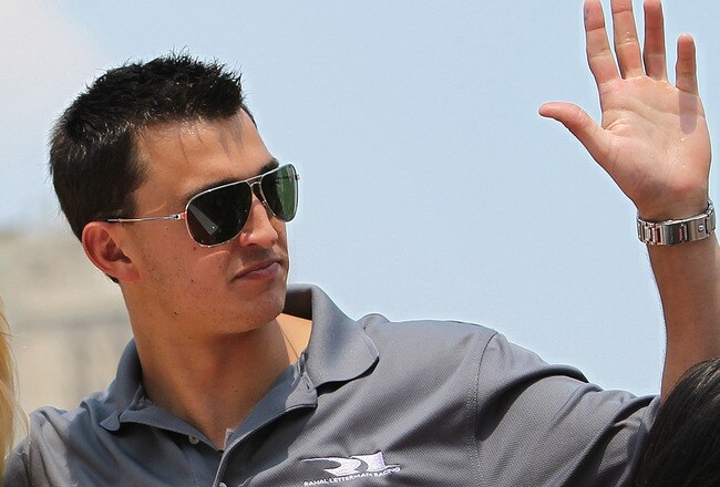 INDIANAPOLIS - MAY 29:  Graham Rahal (C), driver of the #30 Quick Trim Rahal Letterman Racing Special Dallara Honda, and Kim Kardashian (R) ride in the back of a pickup truck during the Indianapolis 500 Festival Parade on May 29, 2010 in downtown Indianapolis, Indiana.  (Photo by Nick Laham/Getty Images)