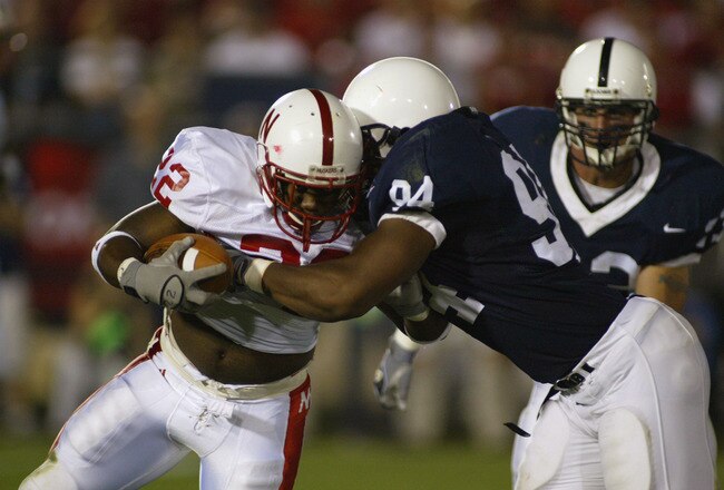 UNIVERSITY PARK, PA - SEPTEMBER 14:  Cory Ross #22 of Nebraska is tackled by Derek Wake #94 of Penn State during the NCAA football game at Beaver Stadium in University Park, Pennsylvania on September 14, 2002. The Penn State Nittany Lions defeated the Nebraska Huskers 40-7.  (Photo by Rick Stewart /Getty Images)