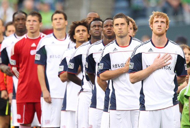 SEATTLE - JUNE 05:  Members of the New England Revolution stand at attention during the national anthem prior to the game against the Seattle Sounders FC on June 5, 2010 at Qwest Field in Seattle, Washington. The Sounders defeated the Revolution 3-0. (Photo by Otto Greule Jr/Getty Images)