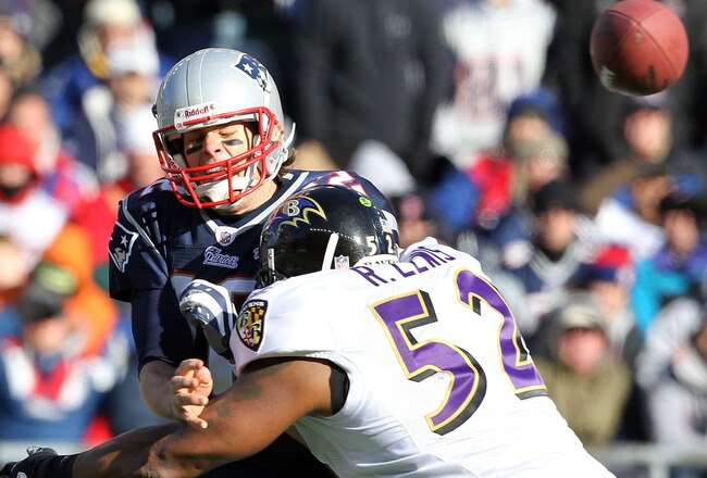 FOXBORO, MA - JANUARY 10:  Tom Brady #12 of the New England Patriots is hit as he throws the ball by Ray Lewis #52 of the Baltimore Ravens during the 2010 AFC wild-card playoff game at Gillette Stadium on January 10, 2010 in Foxboro, Massachusetts.  (Photo by Jim Rogash/Getty Images)