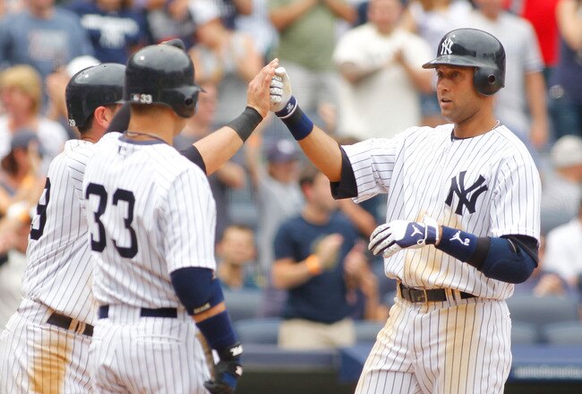 NEW YORK - JUNE 12:  Derek Jeter #2 of the New York Yankees is greeted at home plate after hitting his second home run of the game against the Houston Astros on June 12, 2010 at Yankee Stadium in the Bronx borough of New York City. Yankees defeat the Astros 9-3. (Photo by Mike Stobe/Getty Images)