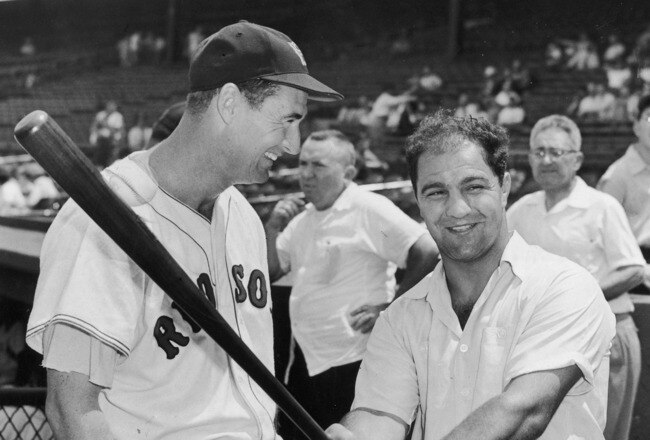 BOSTON - CIRCA 1955:  (UNDATED FILE PHOTO) Baseball legend Ted Williams (1918 - 2002) of the Boston Red Sox (L) laughs as American boxing great Rocky Marciano (1923 - 1969) swings a bat circa 1955. The 83-year-old Williams, who was the last major league player to bat .400 when he hit .406 in 1941, died July 5, 2002 at Citrus County Memorial Hospital in Florida. He died of an apparent heart attack.  (Photo by Getty Images)