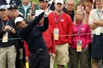 PEBBLE BEACH, CA - JUNE 14:  Tiger Woods hits a shot while patrons look on during a practice round prior to the start of the 110th U.S. Open at Pebble Beach Golf Links on June 14, 2010 in Pebble Beach, California.  (Photo by Ross Kinnaird/Getty Images)