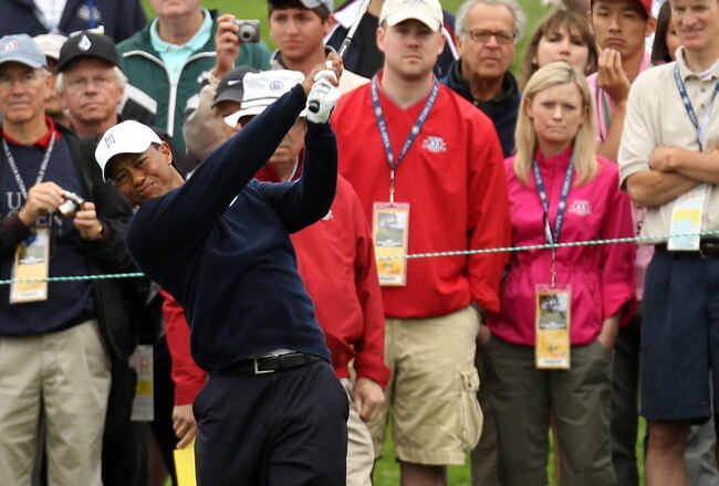 PEBBLE BEACH, CA - JUNE 14:  Tiger Woods hits a shot while patrons look on during a practice round prior to the start of the 110th U.S. Open at Pebble Beach Golf Links on June 14, 2010 in Pebble Beach, California.  (Photo by Ross Kinnaird/Getty Images)