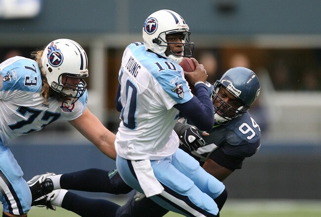 SEATTLE - JANUARY 03:  Quarterback Vince Young #10 of the Tennessee Titans rushes against Cory Redding #94 of the Seattle Seahawks on January 3, 2010 at Qwest Field in Seattle, Washington. The Titans defeated the Seahawks 17-13. (Photo by Otto Greule Jr/Getty Images)