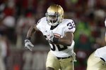 PALO ALTO, CA - NOVEMBER 28:  Theo Riddick #32 of the Notre Dame Fighting Irish runs with the ball during their game against the Stanford Cardinal at Stanford Stadium on November 28, 2009 in Palo Alto, California.  (Photo by Ezra Shaw/Getty Images)