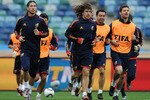 DURBAN, SOUTH AFRICA - JUNE 15:  Carles Puyol (C) of Spain runs with Sergio Ramos (L), Xabi Alonso (R) and other teammates during a training session at the Moses Mabhida Stadium on June 15, 2010 in Durban, South Africa.  (Photo by Jasper Juinen/Getty Images)