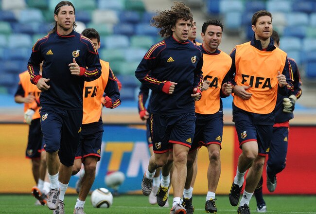 DURBAN, SOUTH AFRICA - JUNE 15:  Carles Puyol (C) of Spain runs with Sergio Ramos (L), Xabi Alonso (R) and other teammates during a training session at the Moses Mabhida Stadium on June 15, 2010 in Durban, South Africa.  (Photo by Jasper Juinen/Getty Images)