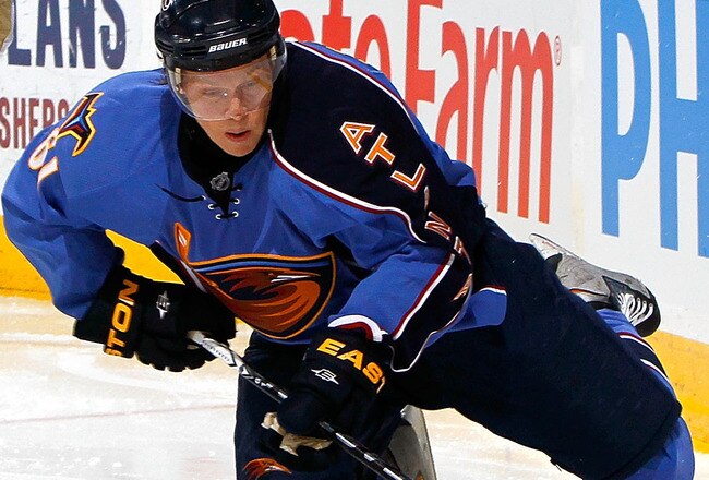 ATLANTA - JANUARY 26:  Maxim Afinogenov #61 of the Atlanta Thrashers controls the puck against Todd Marchant #22 of the Anaheim Ducks at Philips Arena on January 26, 2010 in Atlanta, Georgia.  (Photo by Kevin C. Cox/Getty Images)
