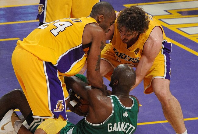 LOS ANGELES, CA - JUNE 15:  Kevin Garnett #5 of the Boston Celtics tries to hold on to the ball under pressure from Kobe Bryant #24, Derek Fisher #2 and Pau Gasol #16 of the Los Angeles Lakers in the first half of Game Six of the 2010 NBA Finals at Staples Center on June 15, 2010 in Los Angeles, California.  NOTE TO USER: User expressly acknowledges and agrees that, by downloading and/or using this Photograph, user is consenting to the terms and conditions of the Getty Images License Agreement.  (Photo by Lisa Blumenfeld/Getty Images)