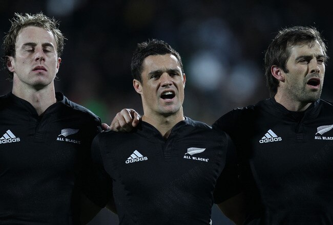 NEW PLYMOUTH, NEW ZEALAND - JUNE 12:  (L-R) Jimmy Cowan, Dan Carter and Conrad Smith of the All Blacks sing the National Anthem before the game between the New Zealand All Blacks and Ireland at Yarrow Stadium on June 12, 2010 in New Plymouth, New Zealand.  (Photo by Phil Walter/Getty Images)