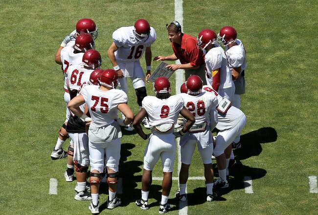 LOS ANGELES, CA - MAY 01:  Head coach Lane Kiffin gives instructions in the offensive huddle during the  USC Trojans spring game on  May 1, 2010 at the Los Angeles Memorial Coliseum in Los Angeles, California.  (Photo by Stephen Dunn/Getty Images)