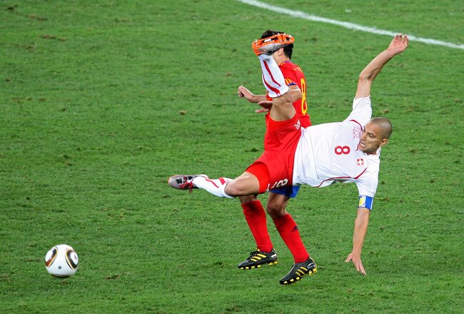 DURBAN, SOUTH AFRICA - JUNE 16:  Gokhan Inler of Switzerland clears the ball from Xavi Hernandez of Spain during the 2010 FIFA World Cup South Africa Group H match between Spain and Switzerland at Durban Stadium on June 16, 2010 in Durban, South Africa.  (Photo by Steve Haag/Getty Images)
