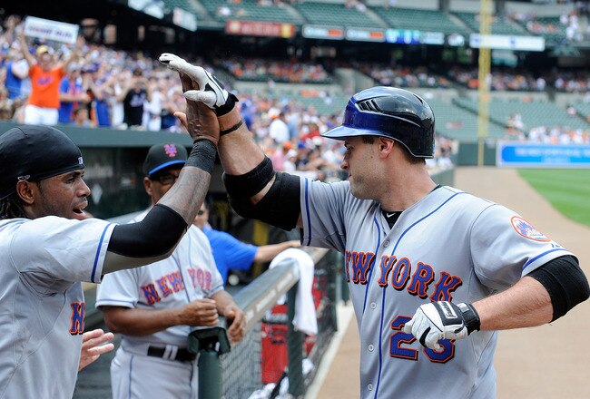 BALTIMORE - JUNE 13:  Chris Carter #23 of the New York Mets celebrates with Jose Reyes #7 after hitting a home run in the first inning against the Baltimore Orioles at Camden Yards on June 13, 2010 in Baltimore, Maryland.  (Photo by Greg Fiume/Getty Images)