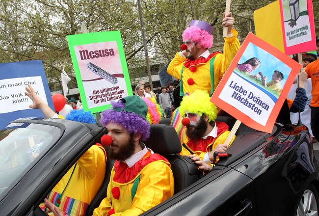 BERLIN - MAY 02:  Orthodox Jews dressed as clowns lead a Jewish parade on May 2, 2010 in Berlin, Germany. The parade, organized by Chabad Lubawitsch Berlin, was the city's first ever Jewish parade since World War II and over a dozen Berlin Jewish organizations participated. Jewish life in Germany has seen a strong revival with the arrival of tens of thousands of Jews from the former Soviet Union since 1989.  (Photo by Sean Gallup/Getty Images)
