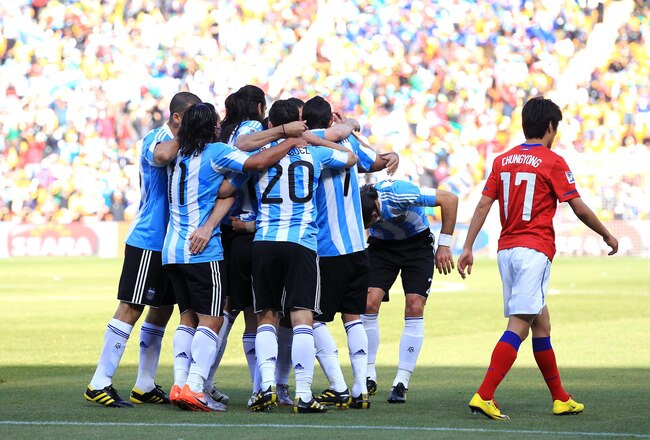 JOHANNESBURG, SOUTH AFRICA - JUNE 17:  Lee Chung-Yong of South Korea walks past Argentina players celebrating an own goal by Park Chu-Young during the 2010 FIFA World Cup South Africa Group B match between Argentina and South Korea at Soccer City Stadium on June 17, 2010 in Johannesburg, South Africa.  (Photo by Chris McGrath/Getty Images)