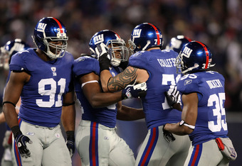 EAST RUTHERFORD, NJ - DECEMBER 13:  Jonathan Goff #54 of the New York Giants celebrates after an interception in the third quarter with teammates Justin Tuck #91 Dave Tollefson #71 and Kevin Dockery #35 against the Philadelphia Eagles at Giants Stadium on December 13, 2009 in East Rutherford, New Jersey.  (Photo by Nick Laham/Getty Images)
