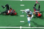 UNIONDALE, NY - MARCH 09:  Charles Frederick #18 of the Kansas City Brigade breaks the tackles of Levy Brown #2 and John Walker #18 of the New York Dragons and heads for the endzone for a touchdown on March 9, 2008 at Nassau Coliseum in Uniondale, New York. The Dragons defeated the Brigade 50-47.  (Photo by Jim McIsaac/Getty Images for the New York Dragons)