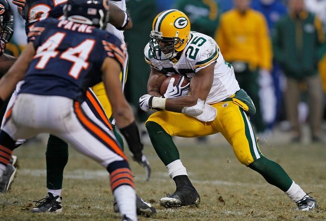 CHICAGO - DECEMBER 13: Ryan Grant #25 of the Green Bay Packers runs for yardage as Kevin Payne #44 of the Chicago Bears closes in at Soldier Field on December 13, 2009 in Chicago, Illinois. The Packers defeated the Bears 21-14. (Photo by Jonathan Daniel/Getty Images)
