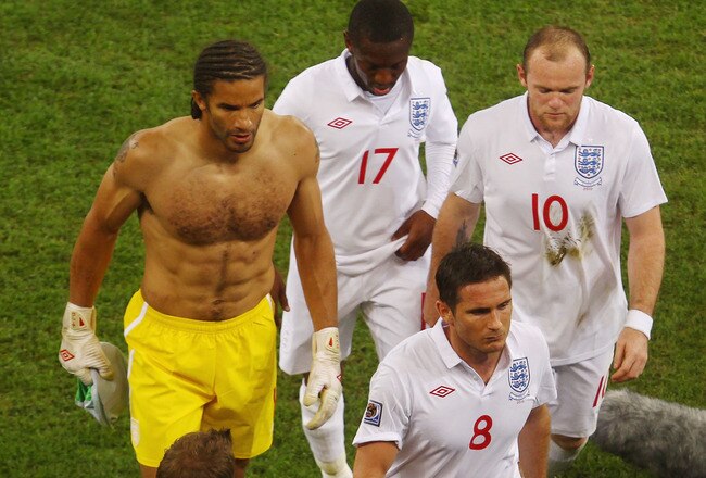 CAPE TOWN, SOUTH AFRICA - JUNE 18:  Fabio Capello manager of England watches his players Frank Lampard, Wayne Rooney, David James and Shaun Wright Phillips walk of the pitch after a draw in the 2010 FIFA World Cup South Africa Group C match between England and Algeria at Green Point Stadium on June 18, 2010 in Cape Town, South Africa.  (Photo by Lars Baron/Getty Images)