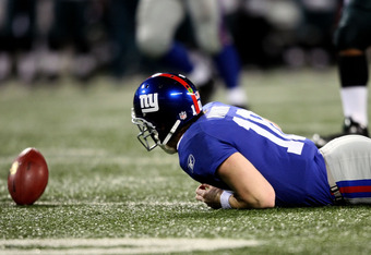 EAST RUTHERFORD, NJ - DECEMBER 13:  Eli Manning #10 of the New York Giants fumbles the ball after a scramble in the third quarter against the Philadelphia Eagles at Giants Stadium on December 13, 2009 in East Rutherford, New Jersey.  (Photo by Nick Laham/Getty Images)