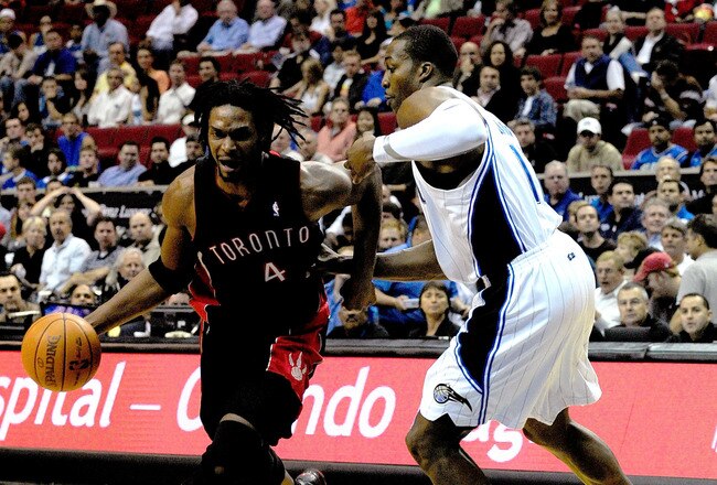ORLANDO, FL - DECEMBER 16:  Chris Bosh #4 of the Toronto Raptors attempts to drives past Dwight Howard #12 of the Orlando Magic during the game at Amway Arena on December 16, 2009 in Orlando, Florida.  NOTE TO USER: User expressly acknowledges and agrees that, by downloading and/or using this Photograph, user is consenting to the terms and conditions of the Getty Images License Agreement.  (Photo by Sam Greenwood/Getty Images)