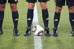 JOHANNESBURG, SOUTH AFRICA - JUNE 20: The referee and asistants stand beside the Jabulani match ball prior to the 2010 FIFA World Cup South Africa Group G match between Brazil and Ivory Coast at Soccer City Stadium on June 20, 2010 in Johannesburg, South Africa.  (Photo by Martin Rose/Getty Images)