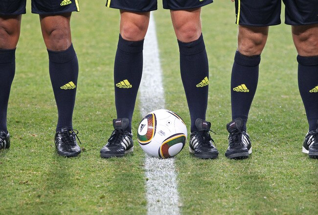 JOHANNESBURG, SOUTH AFRICA - JUNE 20: The referee and asistants stand beside the Jabulani match ball prior to the 2010 FIFA World Cup South Africa Group G match between Brazil and Ivory Coast at Soccer City Stadium on June 20, 2010 in Johannesburg, South Africa.  (Photo by Martin Rose/Getty Images)