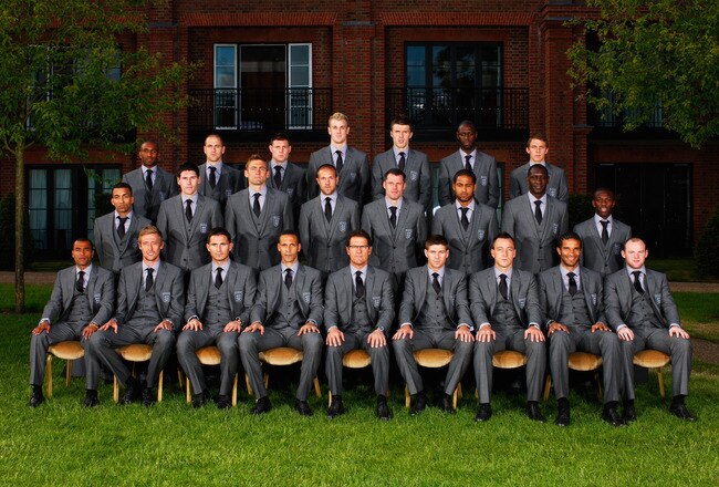 HERTFORD, ENGLAND - JUNE 02: In this handout image supplied by the FA, the England World Cup 2010 squad, wearing their official Marks & Spencer suits (L-R back row) Jermain Defoe, Joe Cole, James Milner, Joe Hart, Michael Carrick, Ledley King and Stephen Warnock, (L-R centre row) Aaron Lennon, Gareth Barry, Robert Green, Matthew Upson, Jamie Carragher, Glen Johnson, Emile Heskey and Shaun Wright-Phillips (L-R front row) Ashley Cole, Peter Crouch, Frank Lampard, captain Rio Ferdinand, manager Fabio Capello, vice-captain Steven Gerrard, John Terry, David James and Wayne Rooney pose for a team photograph as they prepare to leave for South Africa at The Grove Hotel on June 2, 2010 in Hertford, England. (Photo by The FA via Getty Images)