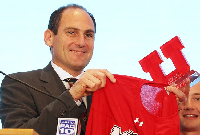 SALT LAKE CITY, UT - JUNE 17: PAC-10 Commissioner Larry Scott hold up University of Utah gear after admitting the University of Utah into the PAC-10 June 17, 2010 in Salt Lake City, Utah. The University of Utah was invited to join the PAC-10 for the 2011-12 athletic year.   (Photo by George Frey/Getty Images)