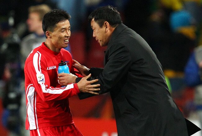 JOHANNESBURG, SOUTH AFRICA - JUNE 15:  Ji Yun-Nam of North Korea is congratulated by Kim Jong-Hun head coach of North Korea on scoring a a goal during the 2010 FIFA World Cup South Africa Group G match between Brazil and North Korea at Ellis Park Stadium on June 15, 2010 in Johannesburg, South Africa.  (Photo by Richard Heathcote/Getty Images)