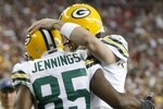 GLENDALE, AZ - JANUARY 10:  Wide receiver Greg Jennings #85 of the Green Bay Packers celebrates a touchdown against the Arizona Cardinals with quarterback Aaron Rodgers #12 during the third quarter of the 2010 NFC wild-card playoff game at University of Phoenix Stadium on January 10, 2010 in Glendale, Arizona.   (Photo by Jeff Gross/Getty Images)