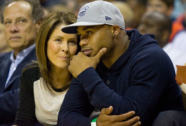 CHARLOTTE, NC - APRIL 26:  Carolina Panthers wide receiver Steve Smith and his wife Angie sit courtside during the NBA basketball game between the Orlando Magic and the Charlotte Bobcats in Game Four of the Eastern Conference Quarterfinals during the 2010 NBA Playoffs at Time Warner Cable Arena on April 26, 2010 in Charlotte, North Carolina. The Magic defeated the Bobcats 99-90 to complete the 4-game sweep.  NOTE TO USER: User expressly acknowledges and agrees that, by downloading and or using this photograph, User is consenting to the terms and conditions of the Getty Images License Agreement. (Photo by Brian A. Westerholt/Getty Images)