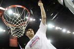 KANSAS CITY, MO - MARCH 13:  Cole Aldrich #45 of the Kansas Jayhawks cuts a piece of the net after the Jayhawks defeated the Kansas State Wildcats to win the 2010 Phillips 66 Big 12 Men's Basketball Championship on March 13, 2010 at the Sprint Center in Kansas City, Missouri.  (Photo by Jamie Squire/Getty Images)