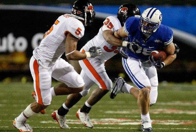 LAS VEGAS - DECEMBER 22:  Andrew George #88 of the Brigham Young University Cougars runs for yardage against Sean Canfield #5 and Keith Pankey #35 of the Oregon State Beavers during the MAACO Las Vegas Bowl at Sam Boyd Stadium December 22, 2009 in Las Vegas, Nevada.  (Photo by Ethan Miller/Getty Images)