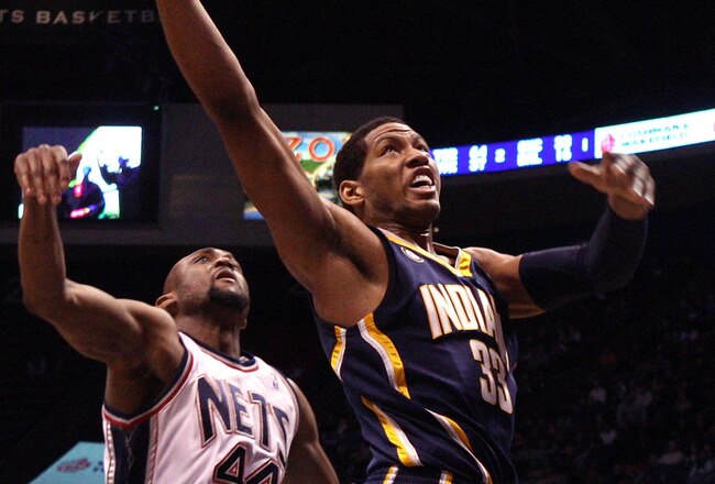 EAST RUTHERFORD, NJ - JANUARY 15:  Danny Granger #33 of the Indiana Pacers drives to the hoop for a basket against Trenton Hassell #44 of the New Jersey Nets at the Izod Center on January 15, 2010 in East Rutherford, New Jersey. NOTE TO USER: User expressly acknowledges and agrees that, by downloading and or using this photograph, User is consenting to the terms and conditions of the Getty Images License Agreement.  (Photo by Jim McIsaac/Getty Images)