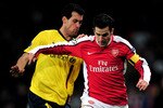 LONDON, ENGLAND - MARCH 31:  Cesc Fabregas (R) of Arsenal is tackled by Sergio Busquets of Barcelona during the UEFA Champions League quarter final first leg match between Arsenal and FC Barcelona at the Emirates Stadium on March 31, 2010 in London, England.  (Photo by Shaun Botterill/Getty Images)