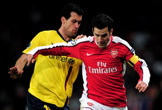 LONDON, ENGLAND - MARCH 31:  Cesc Fabregas (R) of Arsenal is tackled by Sergio Busquets of Barcelona during the UEFA Champions League quarter final first leg match between Arsenal and FC Barcelona at the Emirates Stadium on March 31, 2010 in London, England.  (Photo by Shaun Botterill/Getty Images)