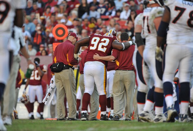 LANDOVER, MD - NOVEMBER 15:  Albert Haynesworth #92 of the Washington Redskins is helped off the field during the game against the Denver Broncos at FedExField on November 15, 2009 in Landover, Maryland. The Redskins defeated the Broncos 27-17. (Photo by Larry French/Getty Images)