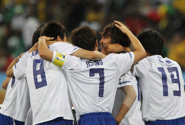 DURBAN, SOUTH AFRICA - JUNE 22:  Park Ji-Sung of South Korea (7) celebrates with goalscorer Park Chu-Young of South Korea (second right) and team mates after he scores from a free kick during the 2010 FIFA World Cup South Africa Group B match between Nigeria and South Korea at Durban Stadium on June 22, 2010 in Durban, South Africa.  (Photo by Doug Pensinger/Getty Images)