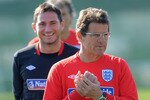 RUSTENBURG, SOUTH AFRICA - JUNE 21:  Frank Lampard smiles as England manager Fabio Capello looks on during the England training session at the Royal Bafokeng Sports Campus on June 21, 2010 in Rustenburg, South Africa.  (Photo by Michael Regan/Getty Images)