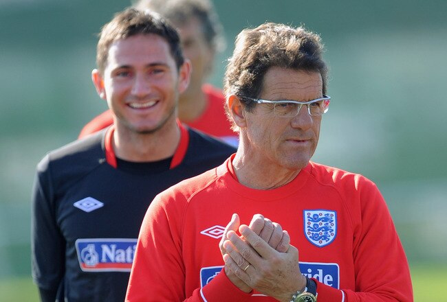 RUSTENBURG, SOUTH AFRICA - JUNE 21:  Frank Lampard smiles as England manager Fabio Capello looks on during the England training session at the Royal Bafokeng Sports Campus on June 21, 2010 in Rustenburg, South Africa.  (Photo by Michael Regan/Getty Images)