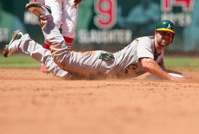 ST. LOUIS - JUNE 20: Kevin Kouzmanoff #5 of the Oakland Athletics slides into second base to avoid a pick off against the St. Louis Cardinals at Busch Stadium on June 20, 2010 in St. Louis, Missouri.  The Athletics beat the Cardinals 3-2.  (Photo by Dilip Vishwanat/Getty Images)